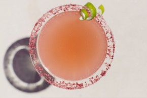 A glass of pink cocktail drink